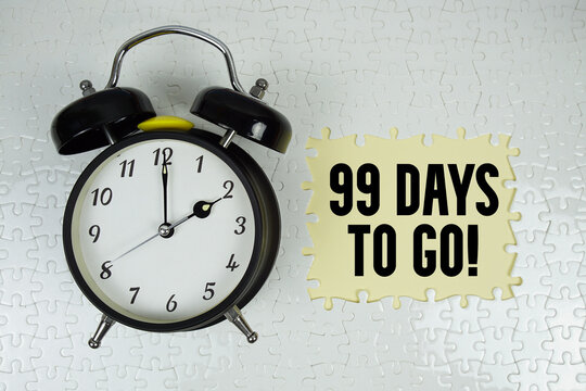 99 Days To Go! text with alarm clock on yellow background