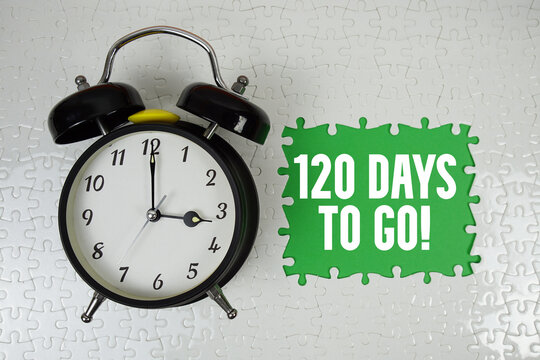 120 Days To Go! text with alarm clock on green background