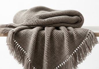 Cozy textured knit throw blanket with fringe detail draped over furniture