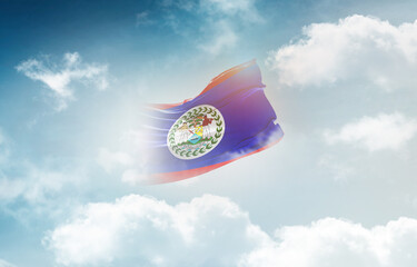 Belize flag waving light background hidden in the sky.