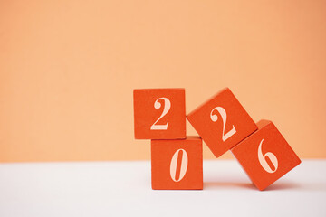 A neat arrangement of orange blocks showcasing the year 2026, offering a clean and simple aesthetic...