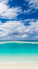 Obraz premium White sand beach, turquoise water, blue sky with fluffy cloudscape, idyllic summer seascape, showcasing serenity and vacation vibes