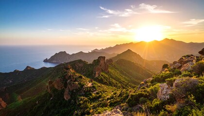 Obraz premium Majestic sunset over a mountain range with a vast ocean vista.
