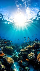 Naklejka premium Sunbeams illuminate a vibrant underwater coral reef teeming with colorful fish