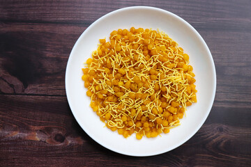 A close up of traditional Indian snacks. crispy savory sev and sweet golden boondi served together. Perfect flavors in authentic Indian namkeen and festive treats. sev bundi.