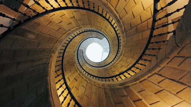 Looking up spiral staircase with hypnotic effect in dark interior