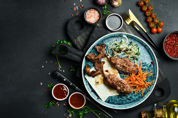 Grilled Lula kebab from lamb on the bone. Azerbaijani cuisine. Free space for text. Close up.