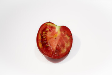 Many fruit flies Drosophila melanogaster feed on tomato slices in a home kitchen, close up of...