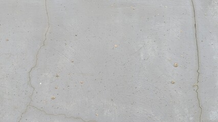 A textured light gray concrete surface with a few fine cracks and speckles. The image provides a...
