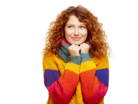 Smiling red-haired woman in colorful sweater posing on white background