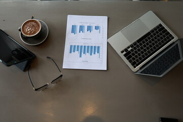 An overflowing office desk with scattered paperwork and documents, symbolizing business planning,...