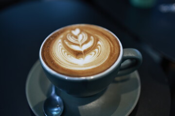 A vintage café scene with a steaming espresso in a white mug on a wooden table, rich with aroma,...