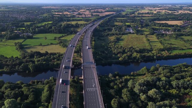 Aerial viedeo of the M6 motorway on Thelwall Viaduct spanning the River Mersey near Warrington, showcasing the twin carriageways