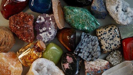 Top view of colorful minerals and crystals—gold, quartz, jasper, jade, amethyst, pyrite, agate,...