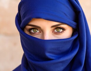 Close-up of Woman in Deep Blue Hijab, Intriguing Eyes.