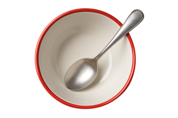 White ceramic bowl with red rim and stainless steel spoon top view, isolated on transparent background
