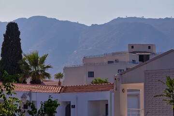 whitewashed buildings with red tile roofs near hazy hills in Icmeler - Marmaris - Mugla - Turkey