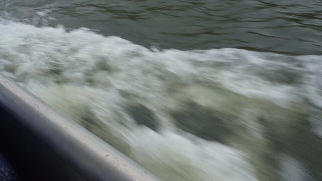 Boat Wake Moving Forward Through Water, View from Deck Looking Down