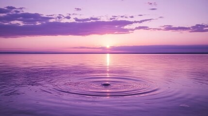 Serene violet sunset over tranquil water with ripples creating a peaceful scene