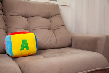 Children's plush dice with the letter A written on them. Letter concept.
