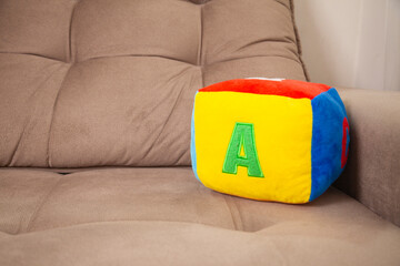 Children's plush dice with the letter A written on them. Letter concept.