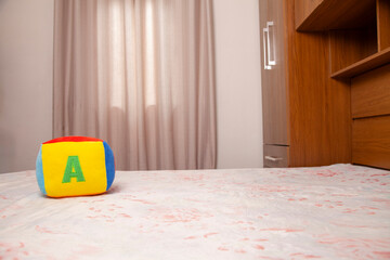 Children's plush dice with the letter A written on them. Letter concept.