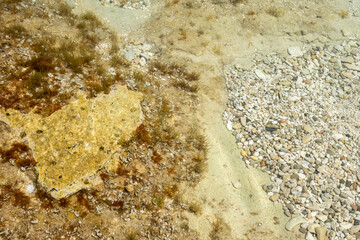 The shore of a pebble beach with clear turquoise water. Likva beach on the island of Brac. Croatia