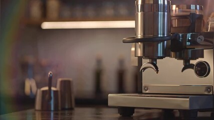 A close up shot of a coffee or espresso machine with coffee dripping slowly