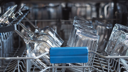 Opened dishwasher with clean dishes