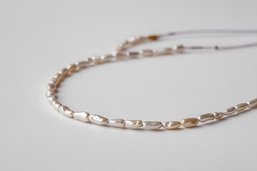 Elegant baroque pearl necklace showcases unique organic shape and luminous glow on a clean white background, perfect for fashion shoots