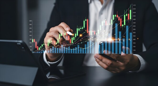 Futuristic digital artwork of hands holding a smartphone and stylus, analyzing holographic stock market data with candlestick and line graphs above a tablet on a dark surface, representing investment 