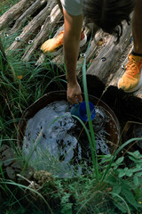 A person drawing water from a spring