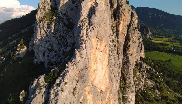 Climbers on a steep rock face - Powered by Adobe