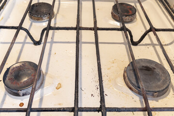 Dirty gas burners on an old gas stove