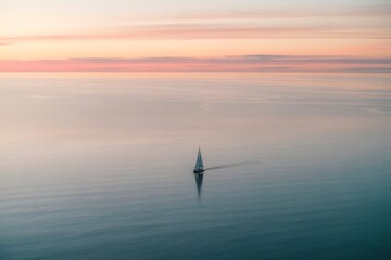 Naklejka premium Sailboat sailing peacefully across the ocean under a stunning pastel sunset sky, serene and calm