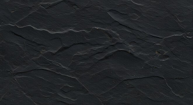A dark gray stone slab shows finelayered texture with subtle lines and surface undulations