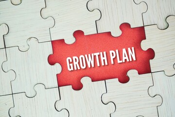 Wooden puzzle with the word Growth Plan. a strategic document that outlines how a business, or an...