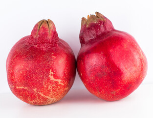 Two Whole Pomegranates on White Minimal Background