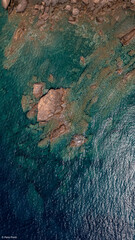 Aerial View of Rocky Coastline with Turquoise Clear Water