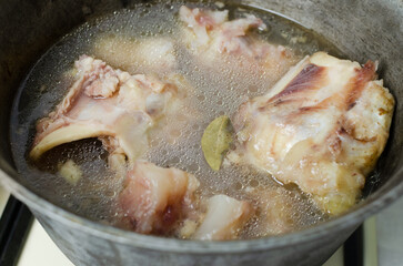 Broth from raw veal bones cooked in a cauldron for 12 hours. Collagen concept. Selective focus. Horizontal orientation.