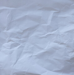 Macro texture of wrinkled white paper with natural folds and creases