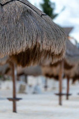 Take a moment to relax beneath the colorful straw umbrellas on a peaceful, beautiful beach,...