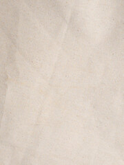 Close-up macro photo of beige cotton fabric texture background