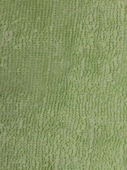 Macro texture of green microfiber fabric surface in closeup detail