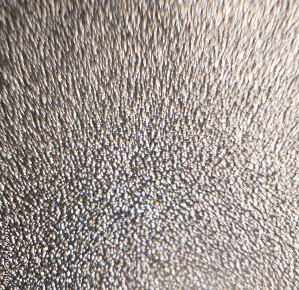 Poster macro close up of textured metallic surface with reflective highlights