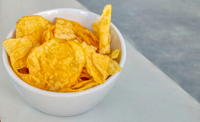 View of potato chips in a white bowl