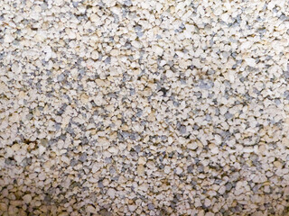 Macro texture of beige stone gravel surface