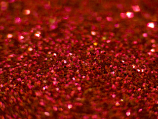 Red glitter macro texture background with sparkling bokeh effect