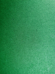 Macro texture photo of green fabric with diagonal weave pattern