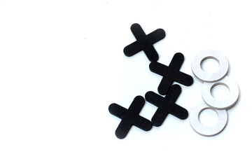 A wooden game set of noughts and crosses on a black background, tic-tac-toe. Tic tac toe game. isolated on white background